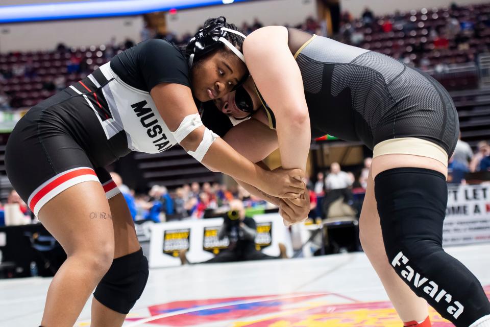 South Western's Davina Crump (left) wrestles Bishop McCort's Alyssa Favara in a 190-pound quarterfinal round bout at the PIAA Class Girls' Wrestling Championships at the Giant Center on March 8, 2024, in Hershey. Favara won by fall at 1:11.