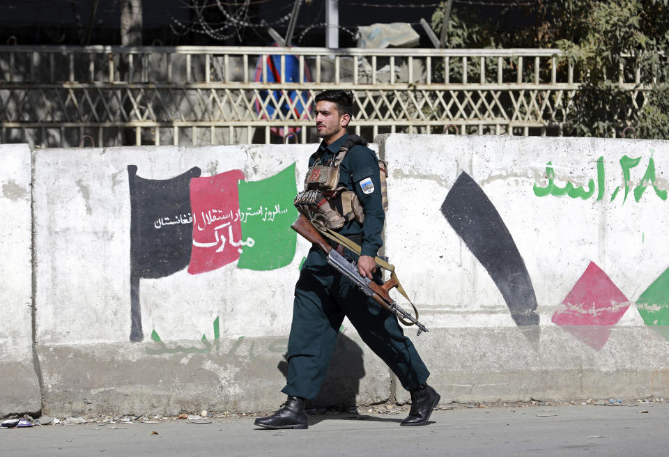 A member of the Afghan security forces arrive at the site of an attack at Kabul University in Kabul, Afghanistan, Monday, Nov. 2, 2020. The brazen attack by gunmen who stormed the university has left many dead and wounded in the Afghan capital. The assault sparked a hours-long gunbattle. (AP Photo/Rahmat Gul)