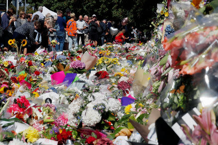 People visit a memorial site for victims of Friday's shooting, in front of Christchurch Botanic Gardens in Christchurch, New Zealand March 19, 2019. REUTERS/Jorge Silva