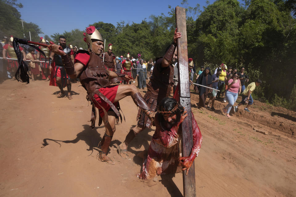Actors perform in a Way of the Cross reenactment as part of Holy Week celebrations, in Atyra, Paraguay, Friday, March 29, 2024. Holy Week commemorates the last week of Jesus Christ’s earthly life which culminates with his crucifixion on Good Friday and his resurrection on Easter Sunday. (AP Photo/Jorge Saenz)
