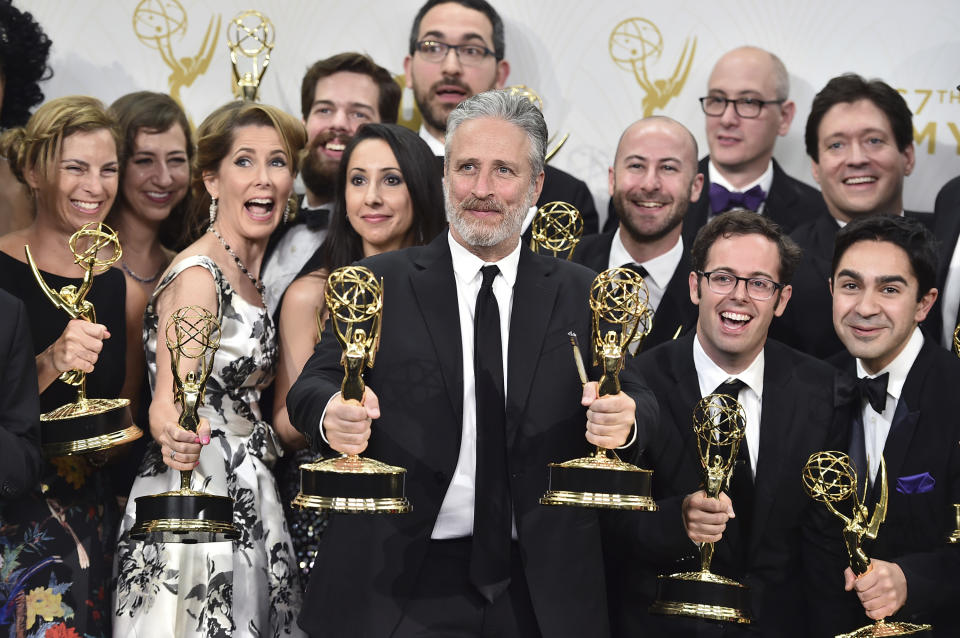 FILE - Jon Stewart, center, poses with the cast and crew, of "The Daily Show with Jon Stewart," winners of the Emmy award for outstanding variety talk series, at the 67th Primetime Emmy Awards in Los Angeles on Sept. 20, 2015. (Photo by Jordan Strauss/Invision/AP, File)