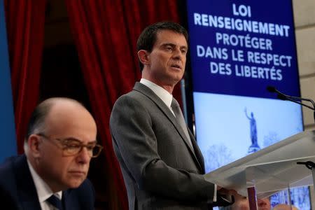 French Prime Minister Manuel Valls speaks during a news conference attended by Interior minister Bernard Cazeneuve (L) at the Elysee Palace in Paris, March 19, 2015. Valls presented the new government draft bill for security and anti-terrorism, which goes to parliament in April for approval. REUTERS/Philippe Wojazer