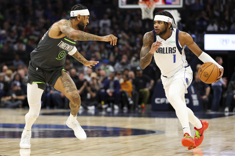 Dallas Mavericks guard Jaden Hardy (1) works toward the basket as Minnesota Timberwolves guard Nickeil Alexander-Walker (9) defends during the first half of an NBA basketball game, Thursday, Dec. 28, 2023, in Minneapolis. (AP Photo/Matt Krohn)