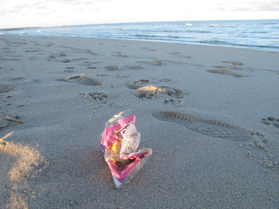 This Feb. 6, 2022, photo shows a discarded snack bag on the sand in Sandy Hook, N.J. On March 30, 2022, the Clean Ocean Action environmental group said over 10,000 volunteers picked up over 513,000 pieces of trash from New Jersey's beaches last year, setting a new record. Plastic items accounted for over 82% of the total. (AP Photo/Wayne Parry)