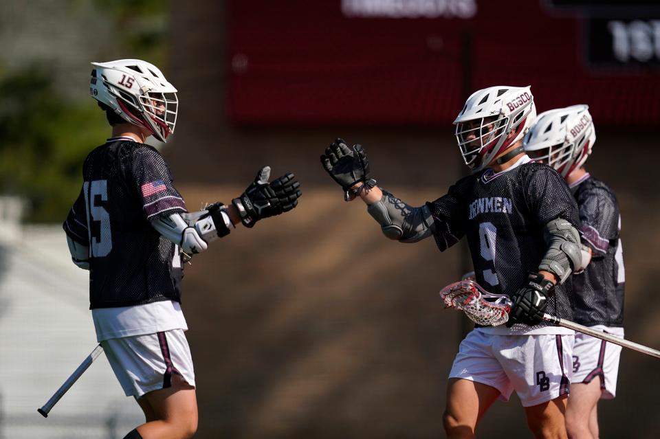 Don Bosco's Brady Scioletti, left, and Johnny Devir celebrate Devir's goal against Don Bosco in the first half during a lacrosse game in Oradell on Thursday, April 20, 2023.