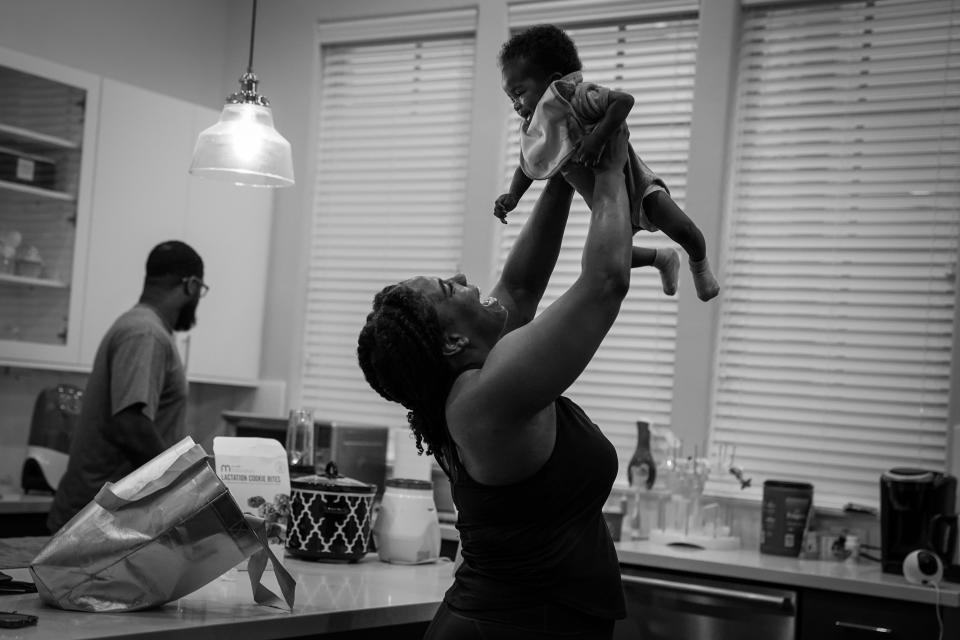 Back from her morning workout and before heading to the law firm where she works, Anderson greets her daughter in March. (Jahi Chikwendiu/The Washington Post)