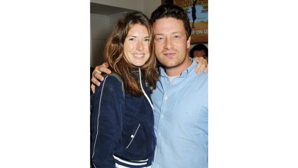 Jools Oliver and Jamie Oliver embracing