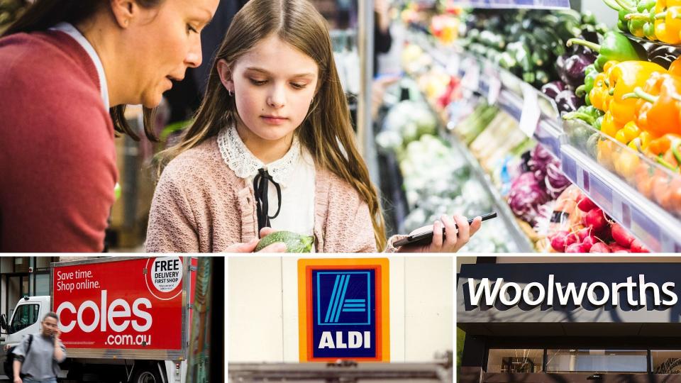 A woman and girl inspecting vegetables, with signs for Coles, Aldi and Woolworths.