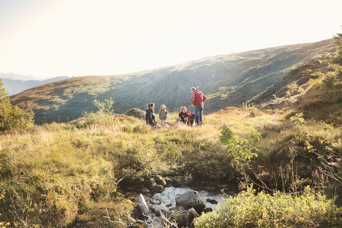 A family camping in nature. We take a look at Steven Rinella's parenting philosophy he calls "radical engagement."