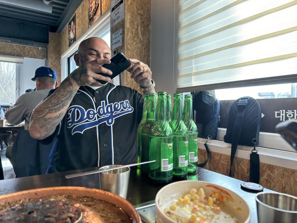 After lunch in the demilitarized zone, a Dodgers fan takes a photo of the beer he and a friend drank.