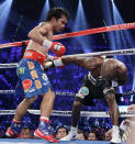 Manny Pacquiao, left, from the Philippines, drives Timothy Bradley, from Palm Springs, Calif., into the ropes in the third round of their WBO welterweight title fight Saturday, June 9, 2012, in Las Vegas.