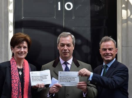 UKIP Leader Nigel Farage (C), UKIP Deputy Chairman and Home Affairs Spokesman Diane James (L) and Peter Whittle, UKIP's London Mayoral candidate (R) stand at the door of the Prime Minister's official residence at 10 Downing Street as they deliver a letter referring to the Britain remaining in the European Union publicity campaign, in London Britain, April 15, 2016. REUTERS/Toby Melville/Files