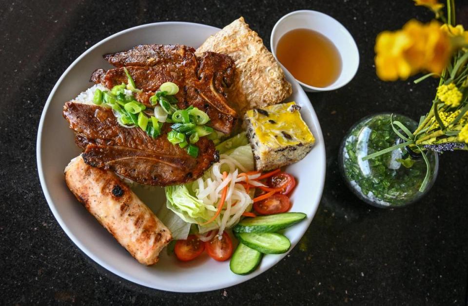 The Saigon broken rice grilled pork chop platter with shrimp paste sugar cane stick, shrimp cake and egg meatloaf served at Sizzle n’ Steam in central Fresno.