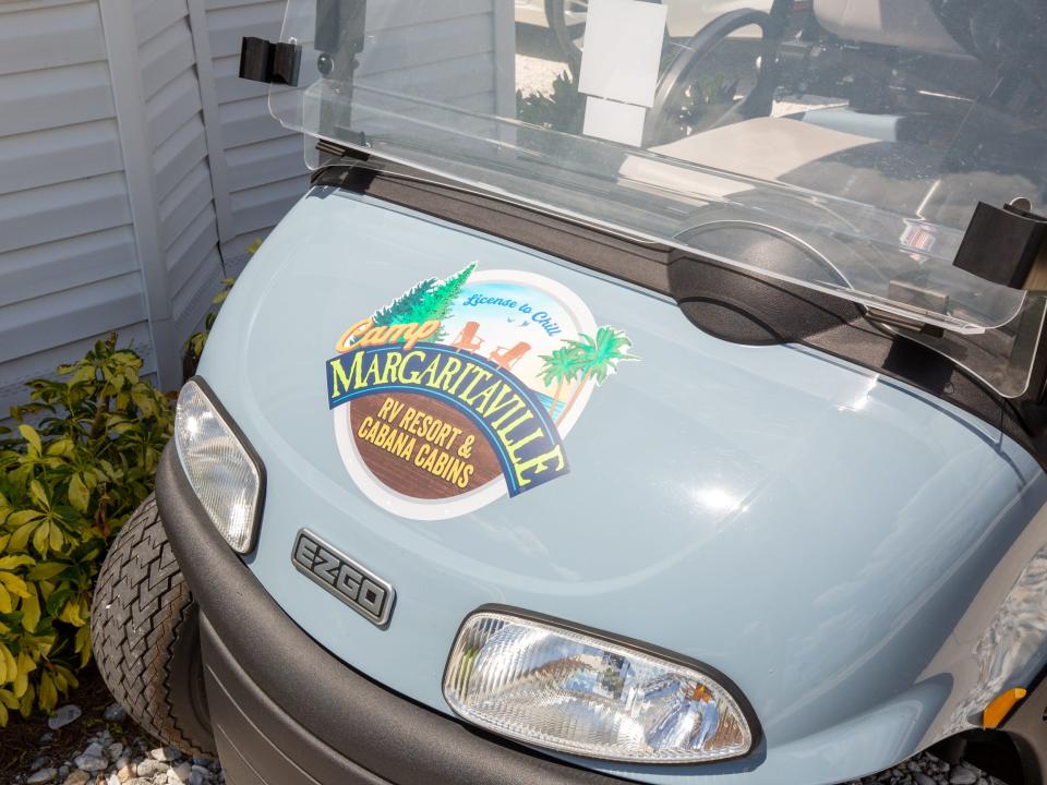 A golf cart with the Camp Margaritaville logo.