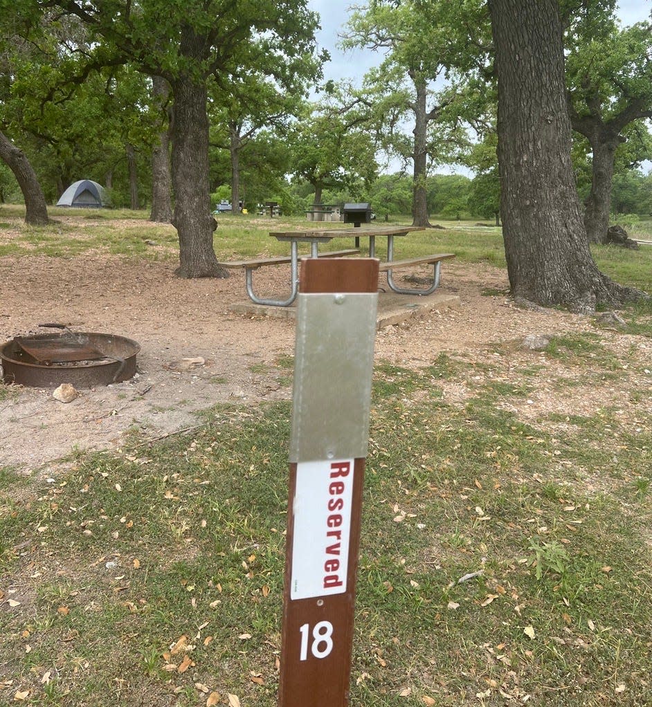 An empty campsite at Pace Bend Park near Spicewood in Travis County is marked reserved, but the campers never showed up.
