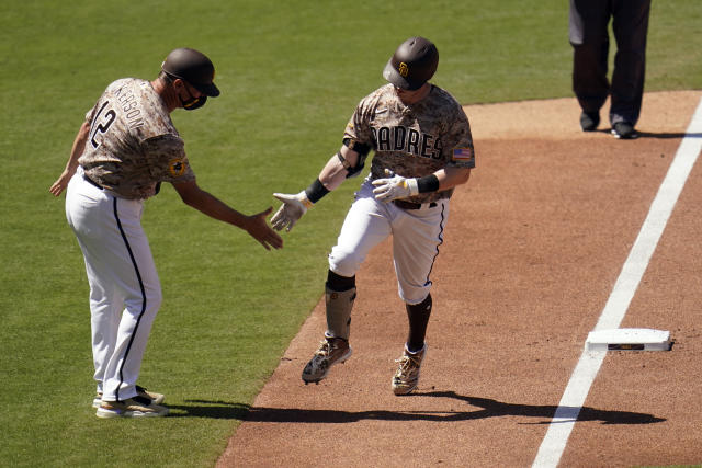 San Diego Padres' Jake Cronenworth is greeted by first base coach