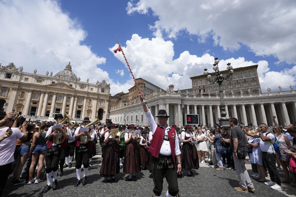 A German folk band performs in front of the Apostolic Palace at The Vatican from where popes bless faithful on Sunday's noon,Sunday, June 11, 2023. Pope Francis, following doctors' advice, skipped Sunday's customary public blessing to allow him to better heal after abdominal surgery. (AP Photo/Alessandra Tarantino)