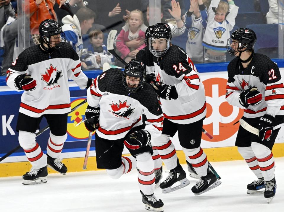 Gavin McKenna, center, of Canada celebrates his 3-3 equalizer on power play during the 2024 IIHF ice hockey U18 world championships final match between the United States and Canada in Espoo, Finland, Sunday, May 5, 2024. 