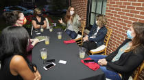 Katie Paris speaks to members of Red, Wine and Blue during a meeting, Monday, Sept. 28, 2020, in Cleveland. With perennial swing-state Ohio appearing to be a toss-up in recent polling, the roles of campaign volunteers and grassroots groups in generating enthusiasm and turning out the vote likely will be crucial in the battle for the state’s 18 electoral votes. With names such as Red, Wine and Blue, Bold New Democracy and Ohio Battleground Alliance, they enable volunteers to pitch in even if they're pinned down at home with children, caregiving needs or their own health concerns. (AP Photo/Tony Dejak)