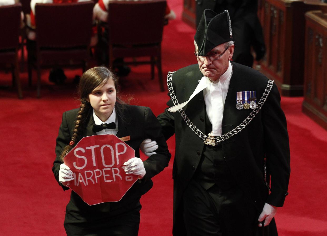 Senate page Brigette DePape, holding a sign reading &quot;Stop Harper&quot; is led from the room by Sergeant-at-Arms Kevin Vickers (R) as Canada&#39;s Governor General David Johnston delivers the Speech from the Throne in the Senate chamber on Parliament Hill in Ottawa in this file photo from June 3, 2011.   According to Veterans Affairs Minister Julian Fantino, Vickers shot dead one of the suspects in the October 22, 2014 shooting incident on Parliament Hill.  A gunman shot and wounded a soldier in Ottawa and then entered the country&#39;s parliament buildings chased by police, with at least 30 shots fired.  REUTERS/Chris Wattie/Files  (CANADA  - Tags:  POLITICS)  REUTERS/Chris Wattie/Files  (CANADA  - Tags:  POLITICS)