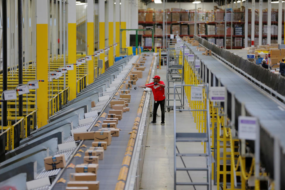 A worker clears a machine jam inside of an Amazon fulfillment center in Robbinsville, New Jersey, U.S., November 27, 2017. REUTERS/Lucas Jackson