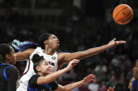 South Carolina forward Aliyah Boston, top, reaches for a rebound against Memphis forward Hannah Riddick during the second half of an NCAA college basketball game Saturday, Dec. 3, 2022, in Columbia, S.C. South Carolina won 79-54. (AP Photo/Sean Rayford)