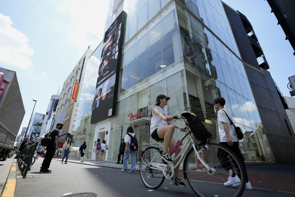 People walk by Fender's Tokyo store Thursday, June 29, 2023. Fender, the guitar of choice for some of the world’s biggest stars from Jimi Hendrix to Eric Clapton, is opening what it calls its “first flagship store” in its 77-year history. (AP Photo/Eugene Hoshiko)