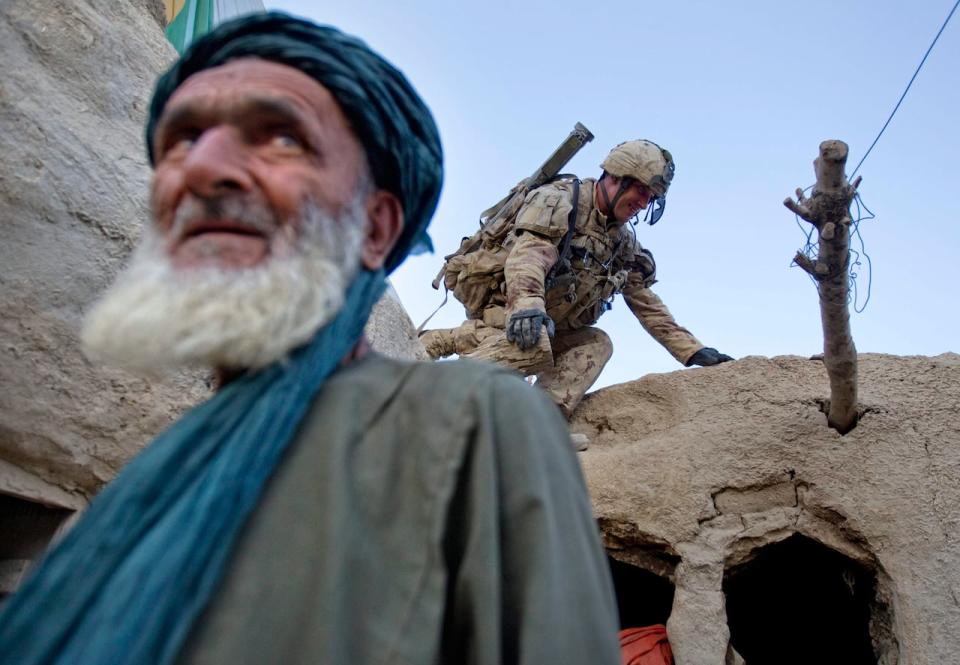 Pvt. Richard Boutet, 38, of Quebec City, searches a compound as the owner Fazel Mohammad, left, looks on during their final operation on June 30, 2011 in the Panjwaii district of Kandahar province, Afghanistan. Canadian combat operations will end in July as troops withdraw from the southern region and hand control over to the Americans. Canada will transition to a non-combat training role with up to 950 soldiers and support staff to train Afghan soldiers and cops in areas of the north, west and Kabul.