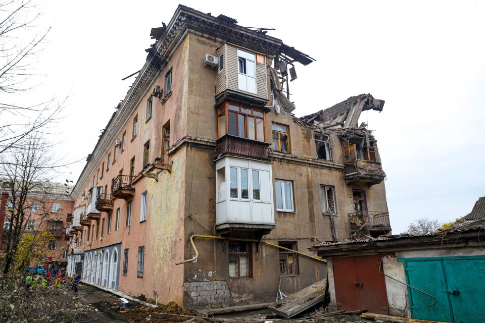 Rescuers, left, work at a site of a damaged apartment building after shelling by Ukrainian forces in Makiivka, Donetsk People's Republic, eastern Ukraine (AP)