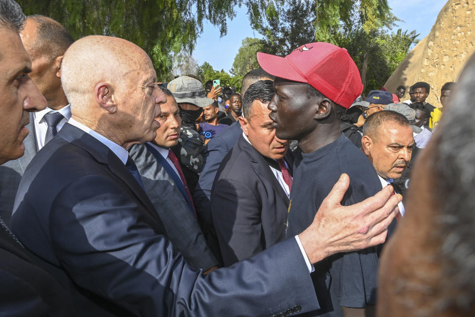 This photo provided by the Tunisian Presidential Palace Sunday June 11, 2023 shows Tunisian President Kais Saied , left, talking to a migrant during a surprise visit to Sfax, Saturday, June 10, 2023. Tunisia is hosting the leaders of Italy, the Netherlands and the European Union on Sunday for talks aimed at smoothing the way for an international bailout and restoring stability to a country that has become a major source of migration to Europe. (Slim Abid/ Tunisian Presidential Palace via AP)