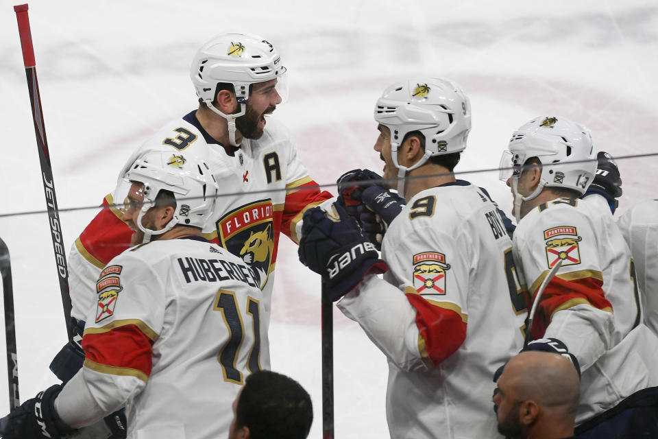 Florida Panthers defenseman Keith Yandle (3) celebrates with Florida Panthers left wing Jonathan Huberdeau (11), Florida Panthers center Brian Boyle (9) and Florida Panthers defenseman Mark Pysyk after Yandle scored against the Minnesota Wild during the first period of an NHL hockey game Monday, Jan. 20, 2020, in St. Paul, Minn. (AP Photo/Craig Lassig)