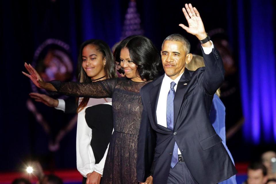 10 Jan 2017: US First Lady Michelle Obama (C) and US President Barack Obama greet supporters as daughter Malia looks on after the President delivered his farewell address in Chicago, Illinois (Joshua Lott/AFP/Getty Images)