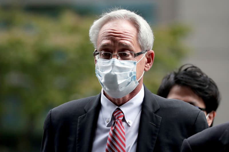 FILE PHOTO: Greg Kelly, former representative director of Nissan Motor Co., arrives for the first trial hearing at the Tokyo District Court in Tokyo