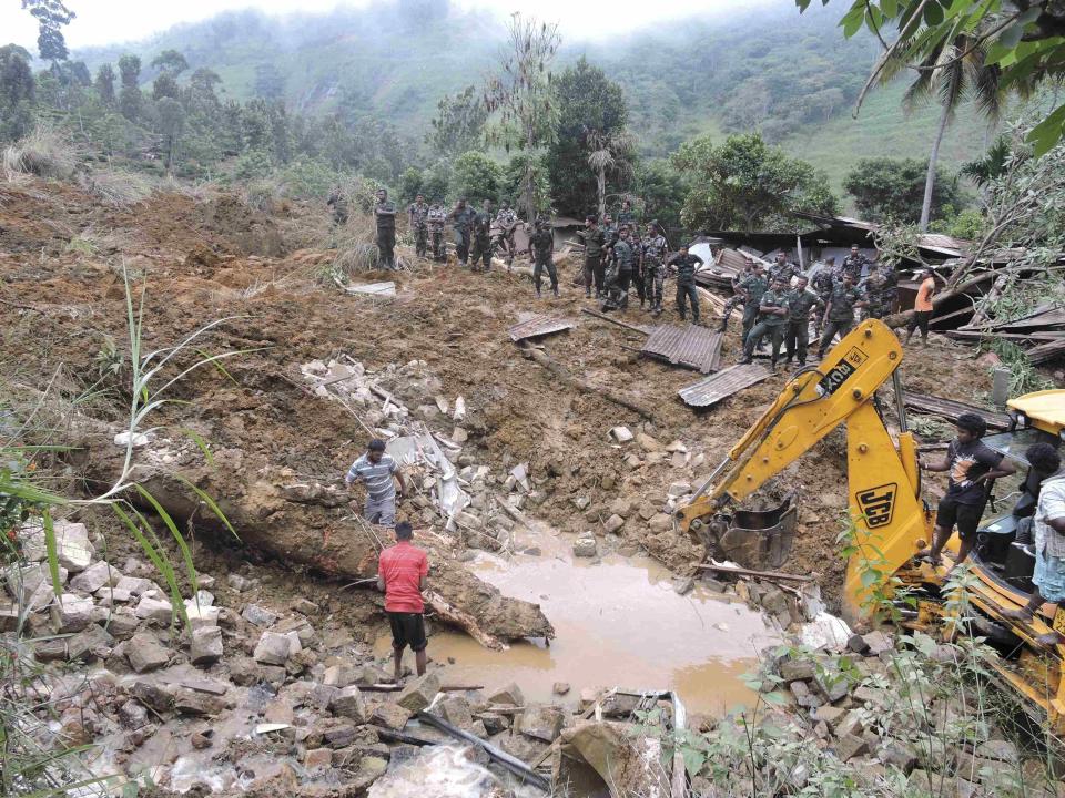 Rescue teams from the Sri Lankan military engage in rescue operation work at the site of a landslide at the Koslanda tea plantation in Badulla