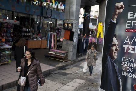 People walk past a banner with an image of opposition leader and head of radical leftist Syriza party, Alexis Tsipras, in Athens January 22, 2015. REUTERS/Marko Djurica