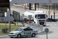 A police car escorts a tanker truck leaving a fuel depot in Aveiras, outside Lisbon, Tuesday, Aug. 13, 2019. Soldiers and police officers are driving tanker trucks to distribute gas in Portugal as an open-ended truckers' strike over pay enters its second day. The government has issued an order allowing the army to be used. (AP Photo/Armando Franca)
