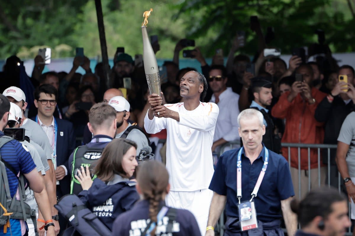 Plenty of well-wishers watched on as Snoop carried the flame (Getty Images)