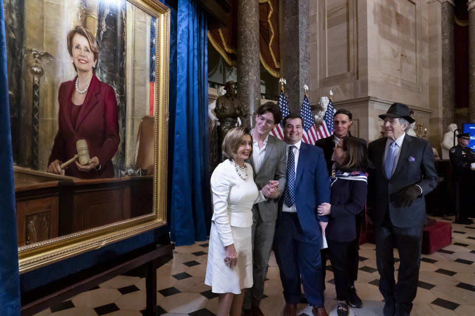 Speaker of the House Nancy Pelosi, D-Calif., is joined by her family and husband Paul Pelosi, far right, as they attend her portrait unveiling ceremony in Statuary Hall at the Capitol in Washington, Wednesday, Dec. 14, 2022. (AP Photo/J. Scott Applewhite)