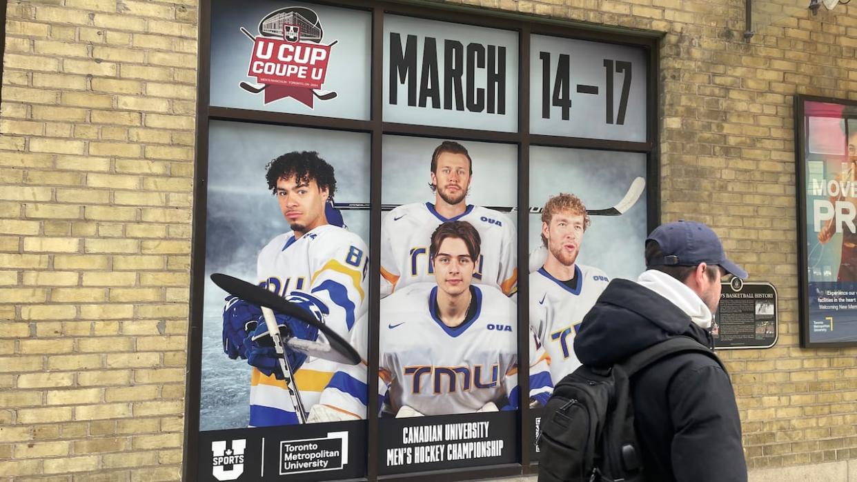 TMU is hosting the Canadian university men's hockey championship, starting today. Kyle Bollers, pictured far left in this advertisement outside Mattamy Athletic Centre, is one of three Black players on the TMU team. He says the team is more diverse than most. (Ethan Lang/CBC - image credit)