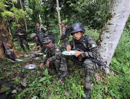 Moro Islamic Liberation Front (MILF) rebels eat their lunch inside their base at Camp Darapan, Sultan Kudarat province, on the southern Philippine island of Mindanao, September 2011. Most of the estimated 100 gunmen holed up in the remote camp on Mindanao island had fled, although two surrendered earlier, said Philippine Army commander Lieutenant-General Arturo Ortiz