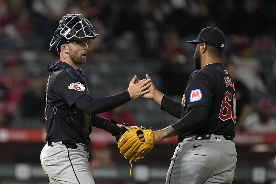 Cleveland Guardians first catcher David Fry, left, and relief pitcher Pedro Avila congratulate each other after the Guardians defeated the Los Angeles Angels 10-4 in a baseball game Friday, May 24, 2024, in Anaheim, Calif. (AP Photo/Mark J. Terrill)