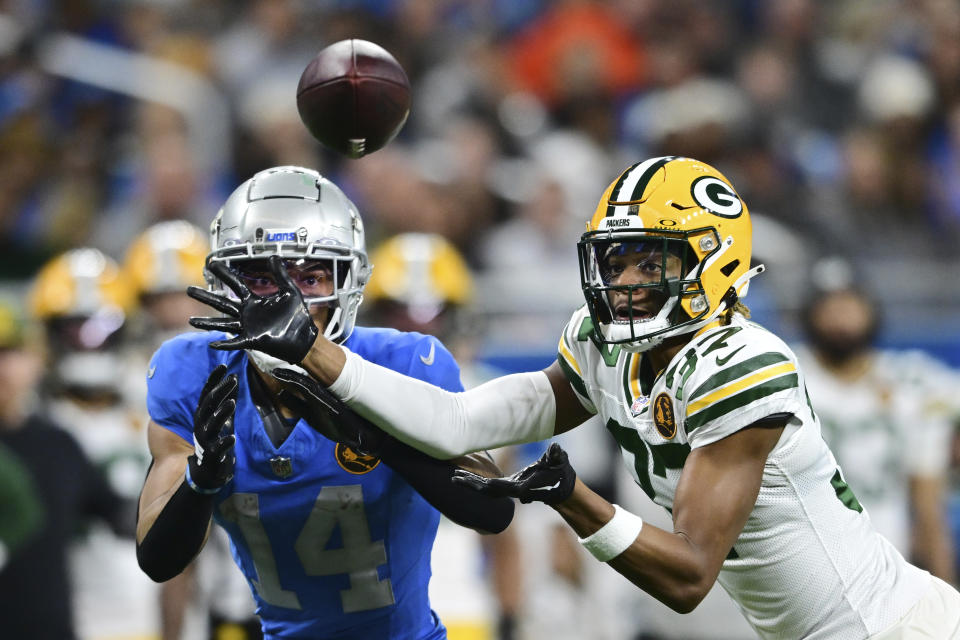 Green Bay Packers cornerback Carrington Valentine (37) deflects a pass intended for Detroit Lions wide receiver Amon-Ra St. Brown (14) during the second half of an NFL football game, Thursday, Nov. 23, 2023, in Detroit. (AP Photo/David Dermer)