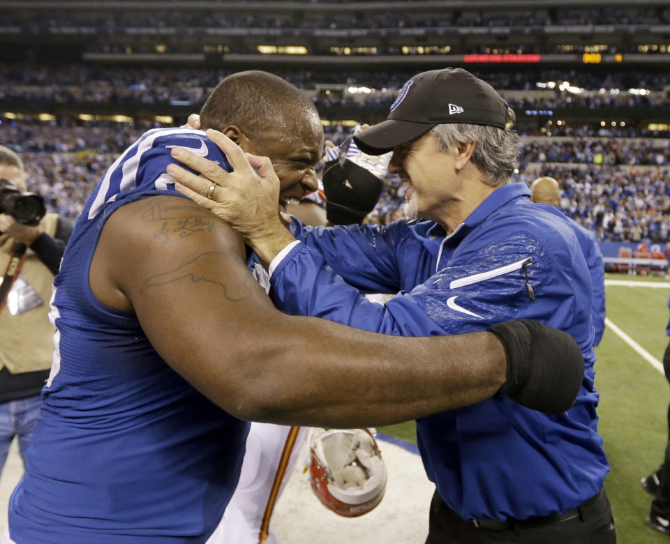 Indianapolis Colts' Cory Redding (90) and Colts head coach Chuck Pagano celebrate after beating Kansas City Chiefs 45-44 at an NFL wild-card playoff football game Saturday, Jan. 4, 2014, in Indianapolis. Indianapolis defeated Kansas City 45-44. (AP Photo/Michael Conroy)