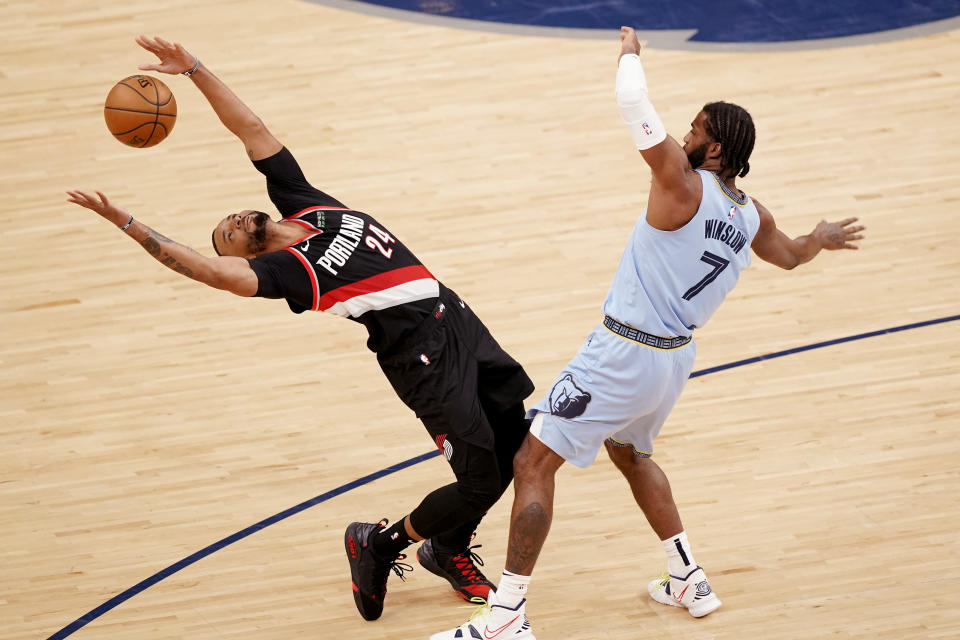 Memphis Grizzlies' Justise Winslow (7) fouls Portland Trail Blazers' Norman Powell (24) in the second half of an NBA basketball game Wednesday, April 28, 2021, in Memphis, Tenn. (AP Photo/Mark Humphrey)