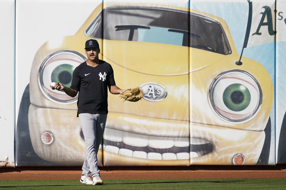 New York Yankees pitcher Greg Weissert fields balls during batting practice before his team's baseball game against the Oakland Athletics in Oakland, Calif., Friday, Aug. 26, 2022. (AP Photo/Jeff Chiu)