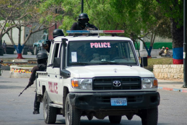 Armed police officers monitor the area after gang violence in the neighborhood on the evening of March 21, 2024, in Port-au-Prince, Haiti, March 22, 2024 (Clarens SIFFROY)