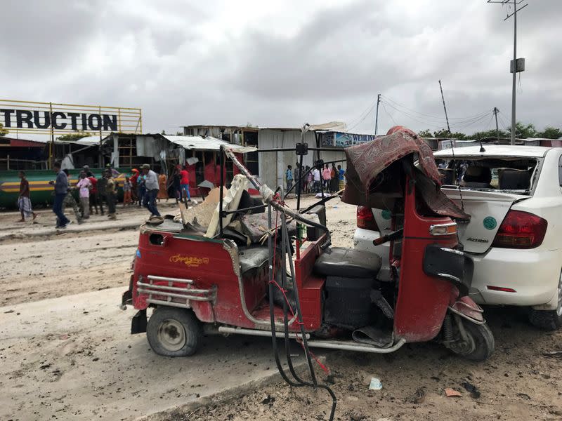 Wreckage of a rickshaw and a car destroyed are seen at the scene of an explosion in Mogadishu