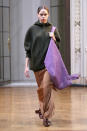 <p>A model carries an oversized purple tote bag from the Victoria Beckham FW18 show. (Photo: Getty Images) </p>