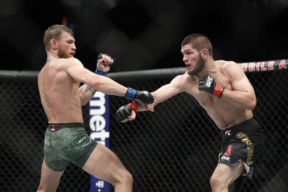 Conor McGregor, left, fights Khabib Nurmagomedov during a UFC 229 mixed martial arts bout Saturday, Oct. 6, 2018, in Las Vegas. (AP Photo/John Locher)