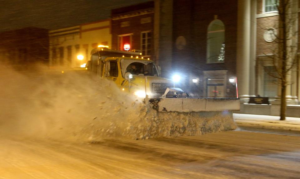 An Indiana Department of Transportation snow plow clears the road at Lincoln Way East and Main Street Thursday, Dec. 22, 2022, in Mishawaka.